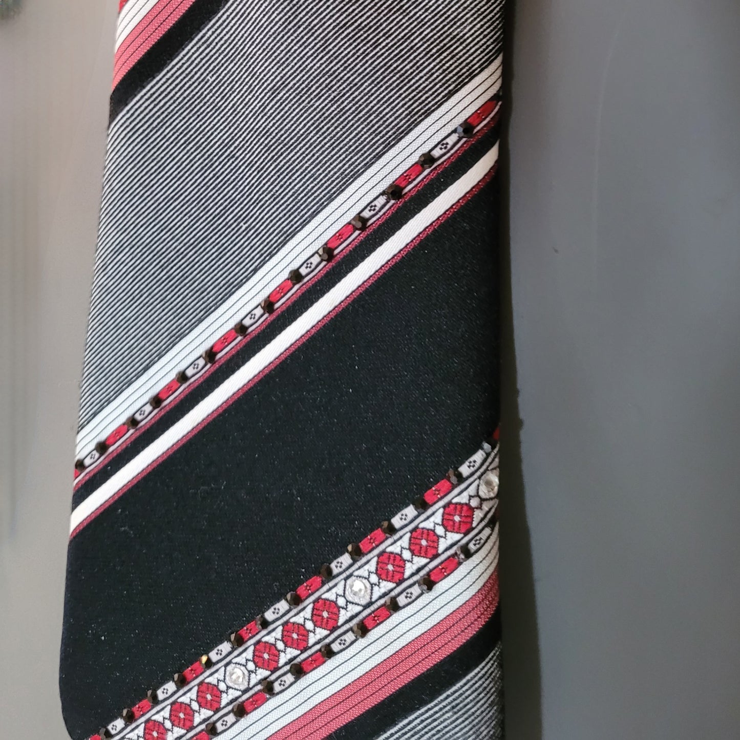 Another Dance collection: End of Beginning tie, original 70's retro diagonally striped polyester necktie in shades of black, gray, white and red adorned with shimmering glass crystals