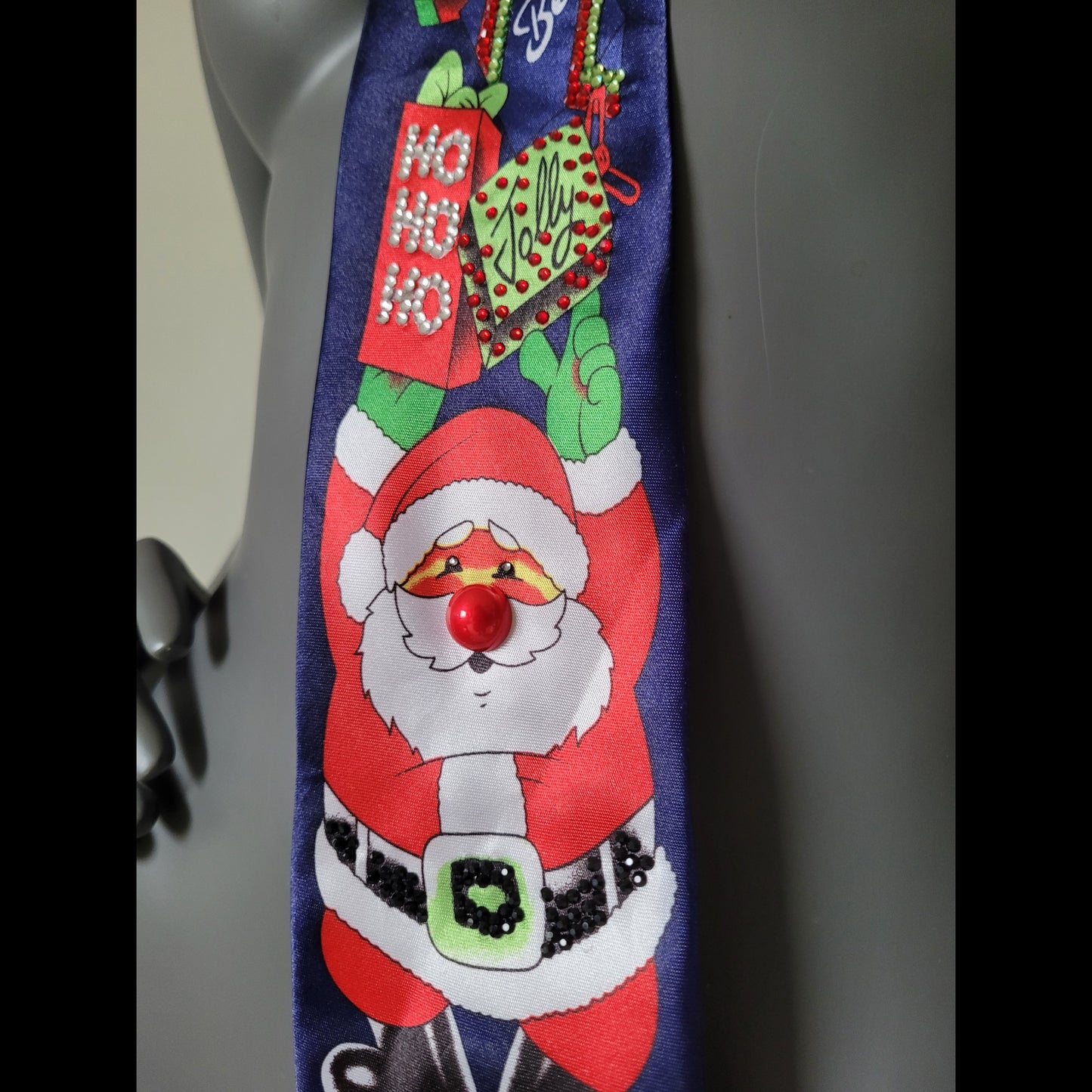 Another Dance collection: Hey Ho tie, maybe the ugliest Christmas tie ever seen, dark marine blue polyester necktie with Santa Claus holding a bunch of gifts adorned with shimmering glass crystals