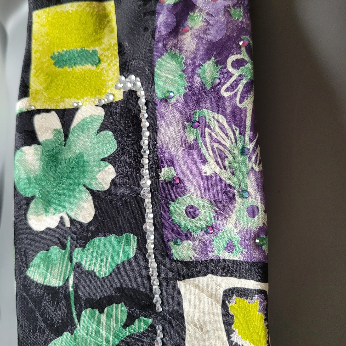 Another Dance collection: Joker tie, retro 90's necktie in black, green, yellow, white and purple with floral and geometrical pattern and clear and Vulcano glass crystals