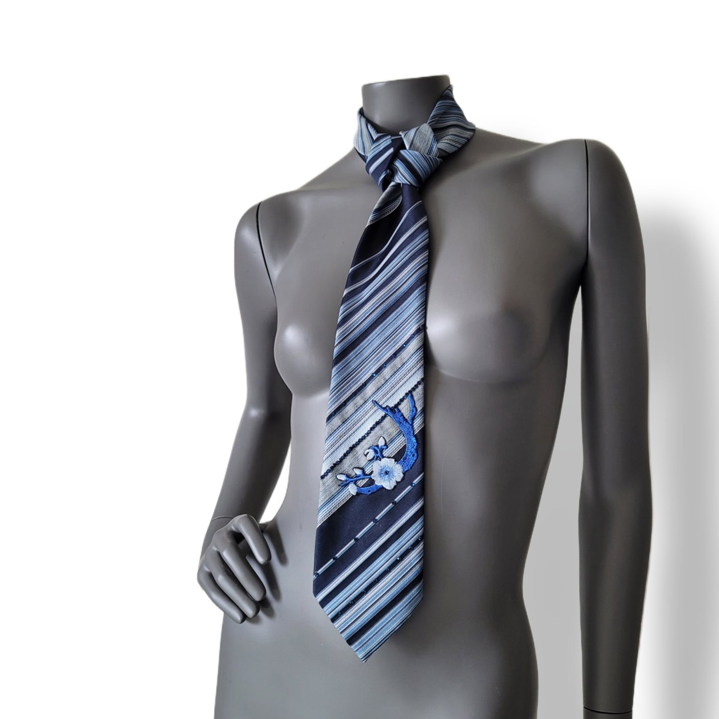 Sakura Blues collection: Sakura Rains tie, striped necktie in shades of blue and white adorned with embroidered cherry blossom appliques and blue glass crystals